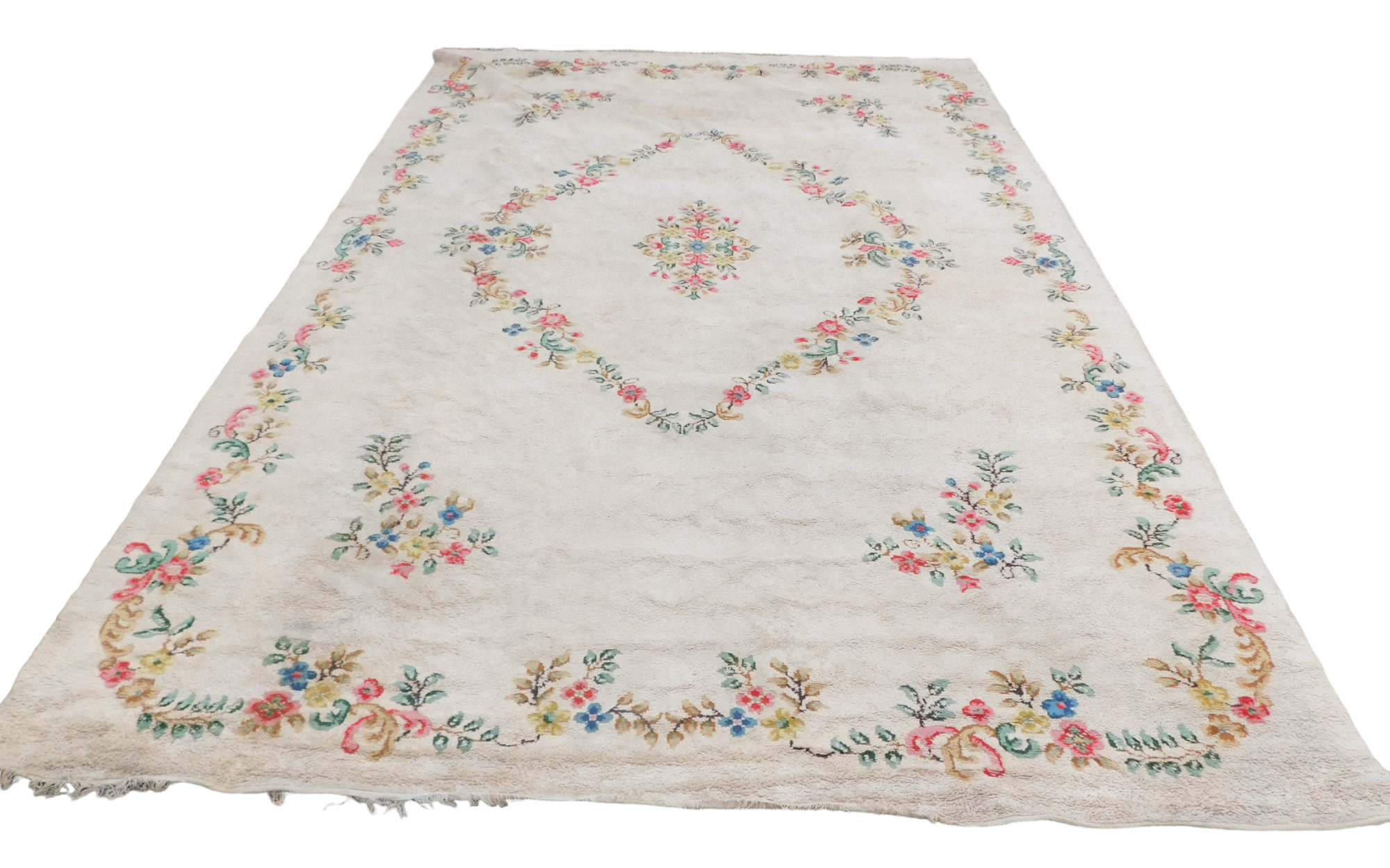 An Indian carpet, with a design of flowers on a cream ground, 540 x 361cm.