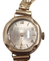 A Doric 9ct gold cased lady's wristwatch, with a silvered dial on gold plated strap, 13.9g all in.