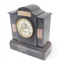 A late 19thC French black slate and marble mantel clock, with enamel dial, 33cm high.