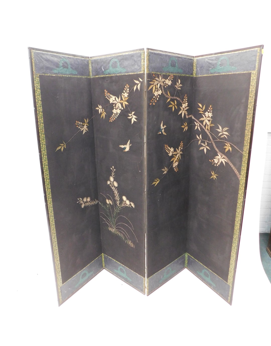 A 20thC ebonised four fold screen, one side embroidered with a design of flowers and leaves within b - Image 3 of 3