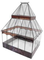 A leaded glass terrarium, the base with purple marbled stained glass panels with an arched roof, 65c