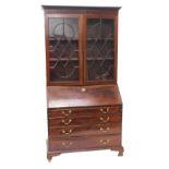 A mahogany bureau bookcase in George III style, the top with two astragal glazed doors, the base wit