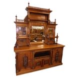 A late 19thC oak sideboard, the raised back with an arrangement of three bevelled mirror plates, two