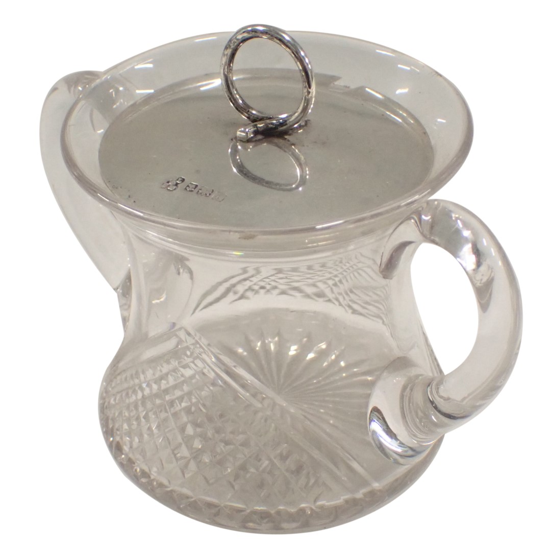 A cut glass two handled preserve jar with silver lid, Birmingham 1909, 0.78oz.