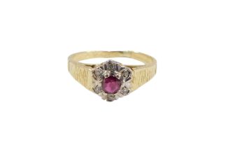 An 18ct gold ruby and diamond cluster ring, set with round brilliant cut ruby, in six claw setting,