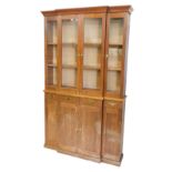 A mahogany breakfront bookcase, the top with a moulded cornice and four glazed doors, the base with