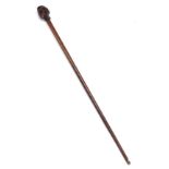 A late 18th/early 19thC walnut and oak walking stick, the handle carved with a head of a gentleman w