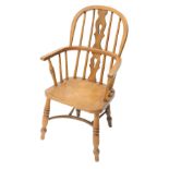 An ash and elm child's Windsor open armchair, with a pierced splat, solid seat, on turned legs, with