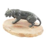 A late 19th/early 20thC Japanese green patinated spelter tiger, mounted on an alabaster ashtray, 27c