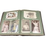 A mid to late 20thC postcard album, containing black and white Foulsham Banfield and other postcards