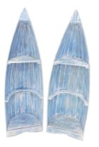 A pair of blue painted boat shaped bookcases or display cabinets, each modelled in the form of a boa