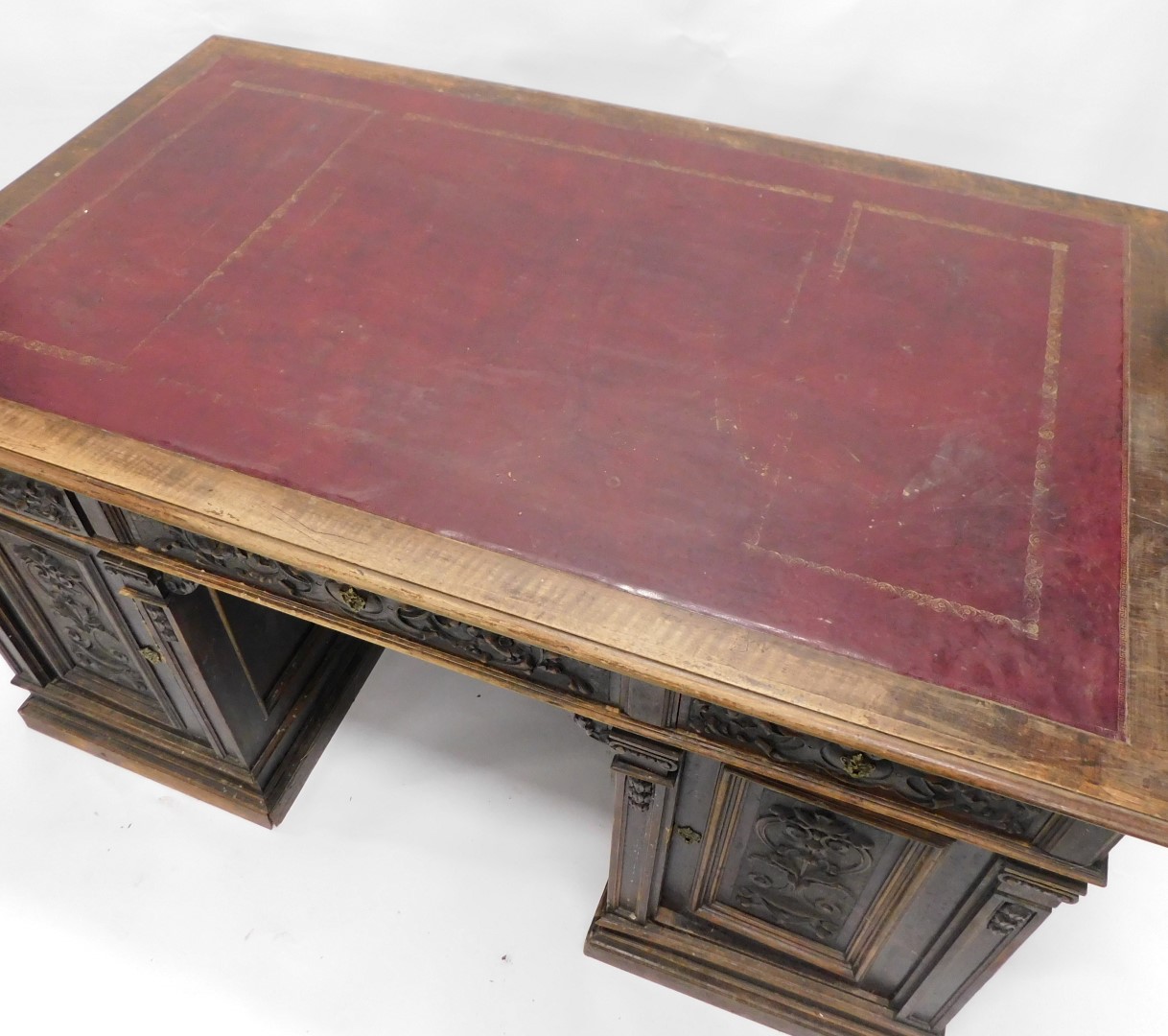A Continental carved oak pedestal desk, the rectangular top with an ox blood red leatherette inset, - Image 2 of 6