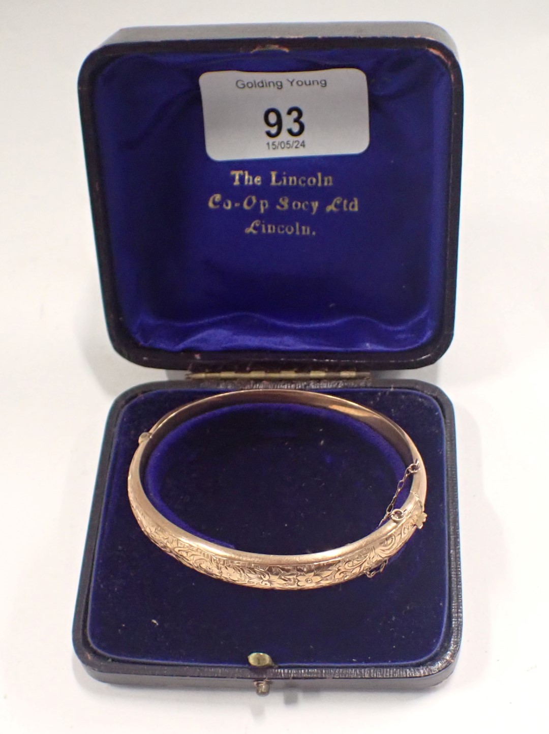 A George V 9ct rose gold hinged bangle, of half hoop design, with floral scroll decoration and safet - Image 4 of 4