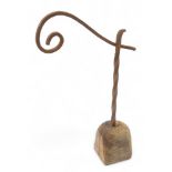 A wrought iron rush light, on wooden base, possibly 18thC, 38cm high.