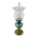 A Victorian oil lamp, with a frosted shade, decorated with flowers, the turquoise glass reservoir de