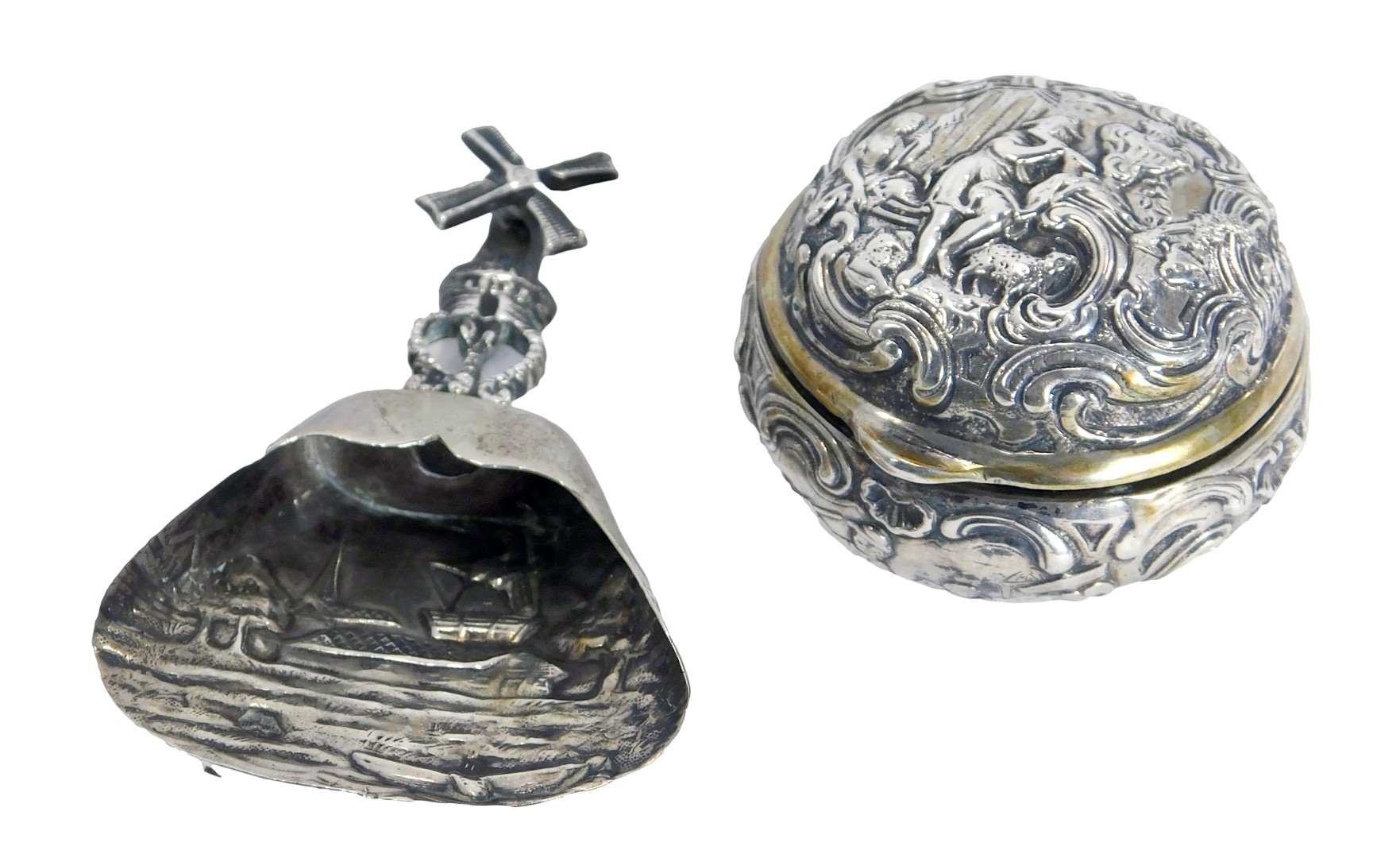 A Continental silver plated pill box, with embossed decoration of figures and animals on scroll deta