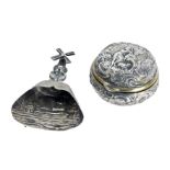 A Continental silver plated pill box, with embossed decoration of figures and animals on scroll deta