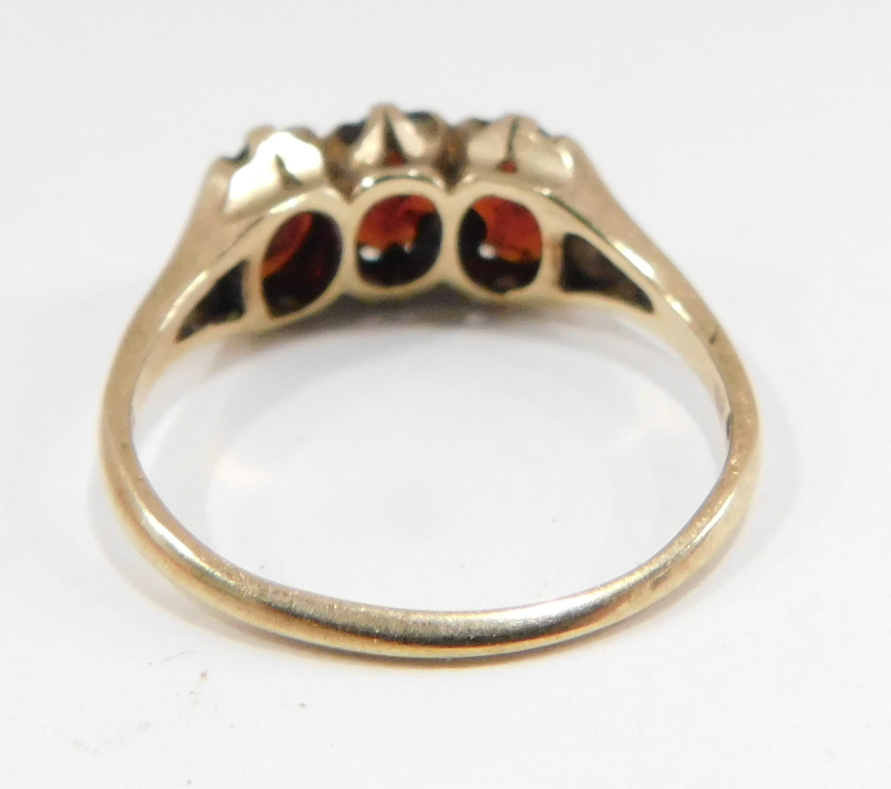 A 9ct gold garnet cluster ring, set with three oval garnets, each in claw setting, on V splayed shou - Image 2 of 2