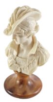 A composition and alabaster bust, modelled in the form of a lady on a wasted socle, 26cm high.