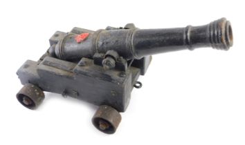 A 19thC signalling cannon, painted black, cast with a single flower head or rose, later painted in r