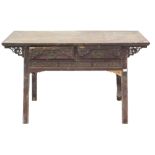 A Chinese red stained altar table, the planked top above two carved frieze drawers each with brass h