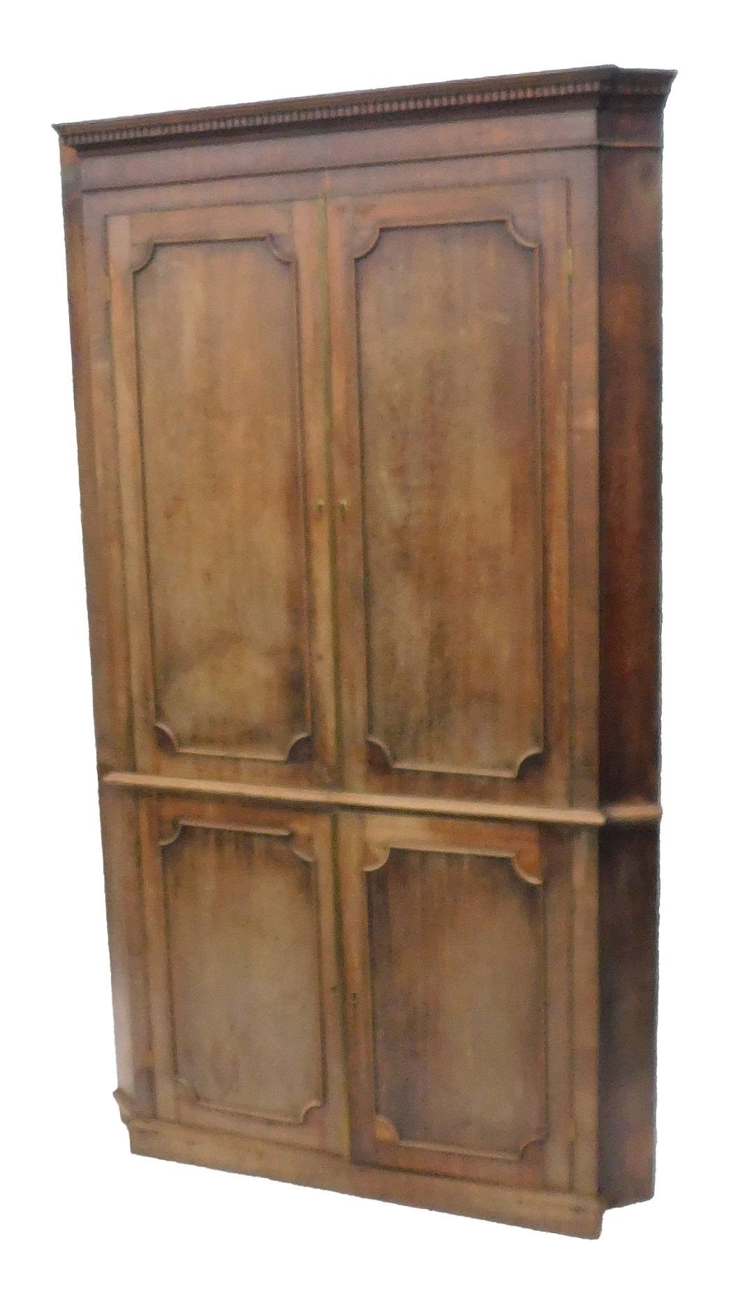 A George III mahogany standing corner cabinet, of breakfront form, with a dental cornice, above two