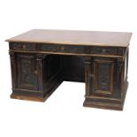A Continental carved oak pedestal desk, the rectangular top with an ox blood red leatherette inset,