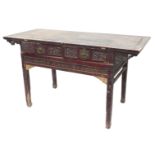 A Chinese red stained altar table, of planked top, with two carved frieze drawers with brass handles