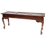 A hardwood display table, the rectangular top with three hinged and glazed doors, on cabriole legs w