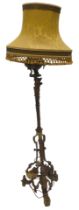 A late 19thC gilt metal floor lamp, decorated in French style with swags, leaves, etc., the triform