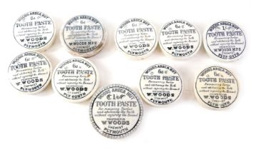 A collection of Woods Areca nut pot lids, and some tooth paste. (AF)