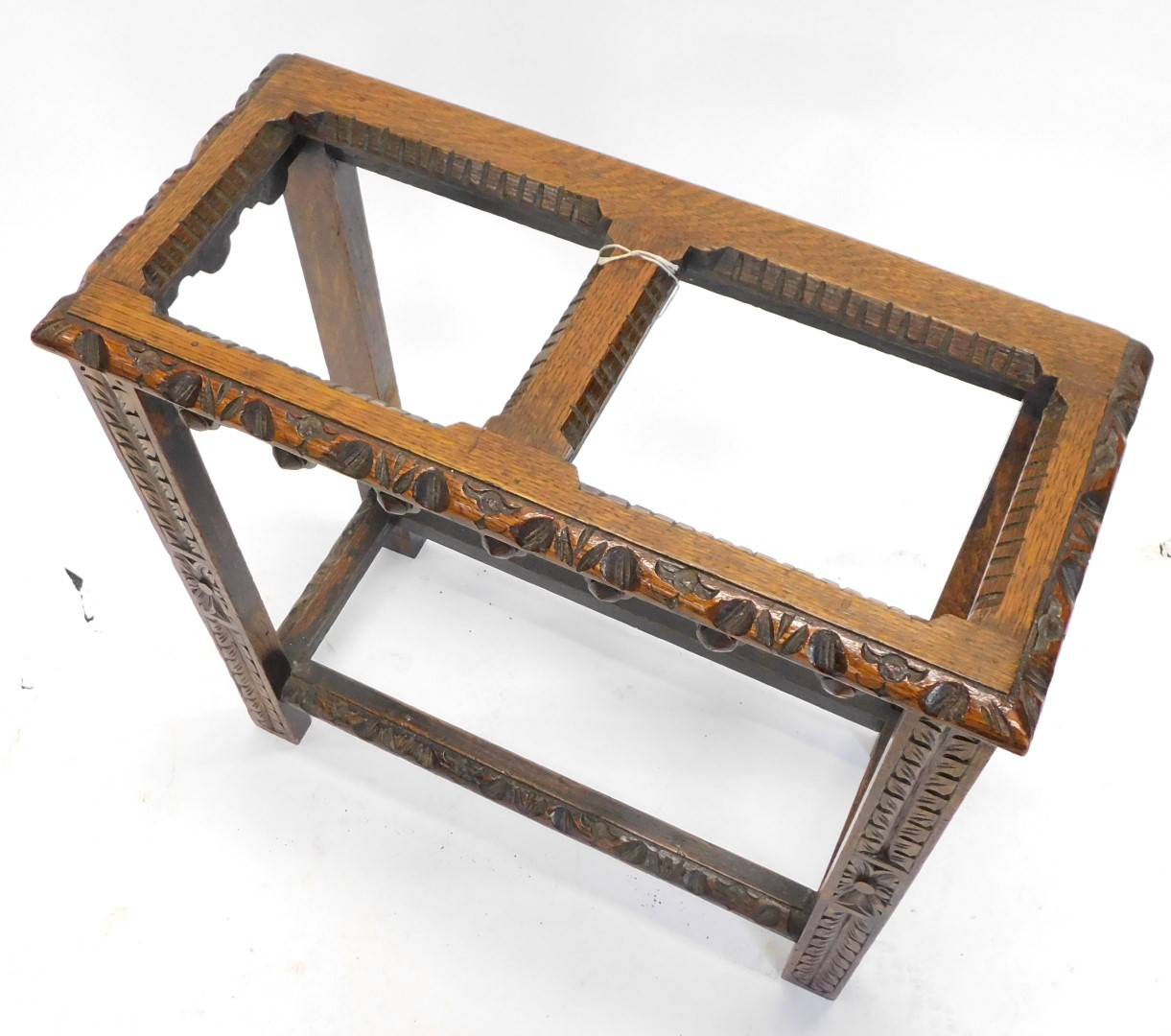 An early 20thC carved oak umbrella stand, with two divisions, lacking liner, 59.5cm wide. - Image 2 of 2