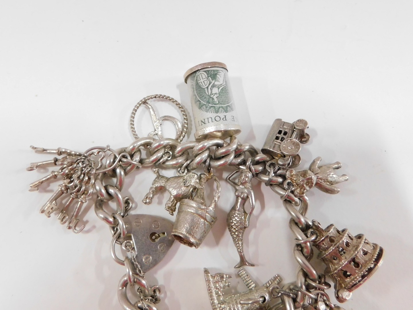 A silver charm bracelet, the curb link bracelet with safety chain and heart shaped padlock stamped s - Image 3 of 3