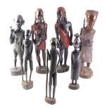 A pair of African tribal male and female figures, each embellished in red, 47cm high, and five other