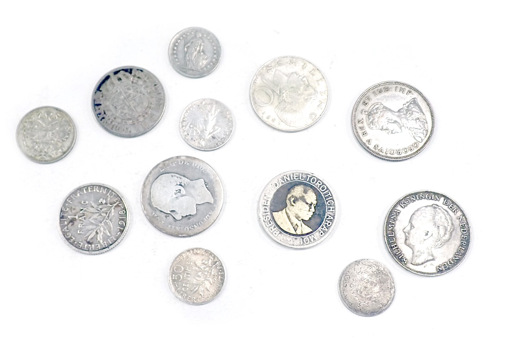 Twelve foreign silver coins, comprising Willhelm, Gustaf and others, 1920s, 1990s, 68g.