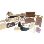 A group of WWII items, to include an ARP axe, a reading shade, armbands, whistle, various eye shield