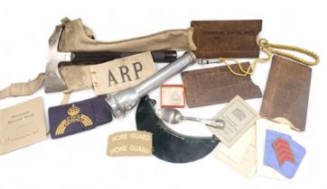 A group of WWII items, to include an ARP axe, a reading shade, armbands, whistle, various eye shield