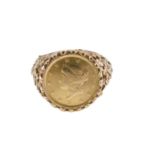 An American one dollar dress ring, the coin in a rub over mount with floral design shoulders dated 1