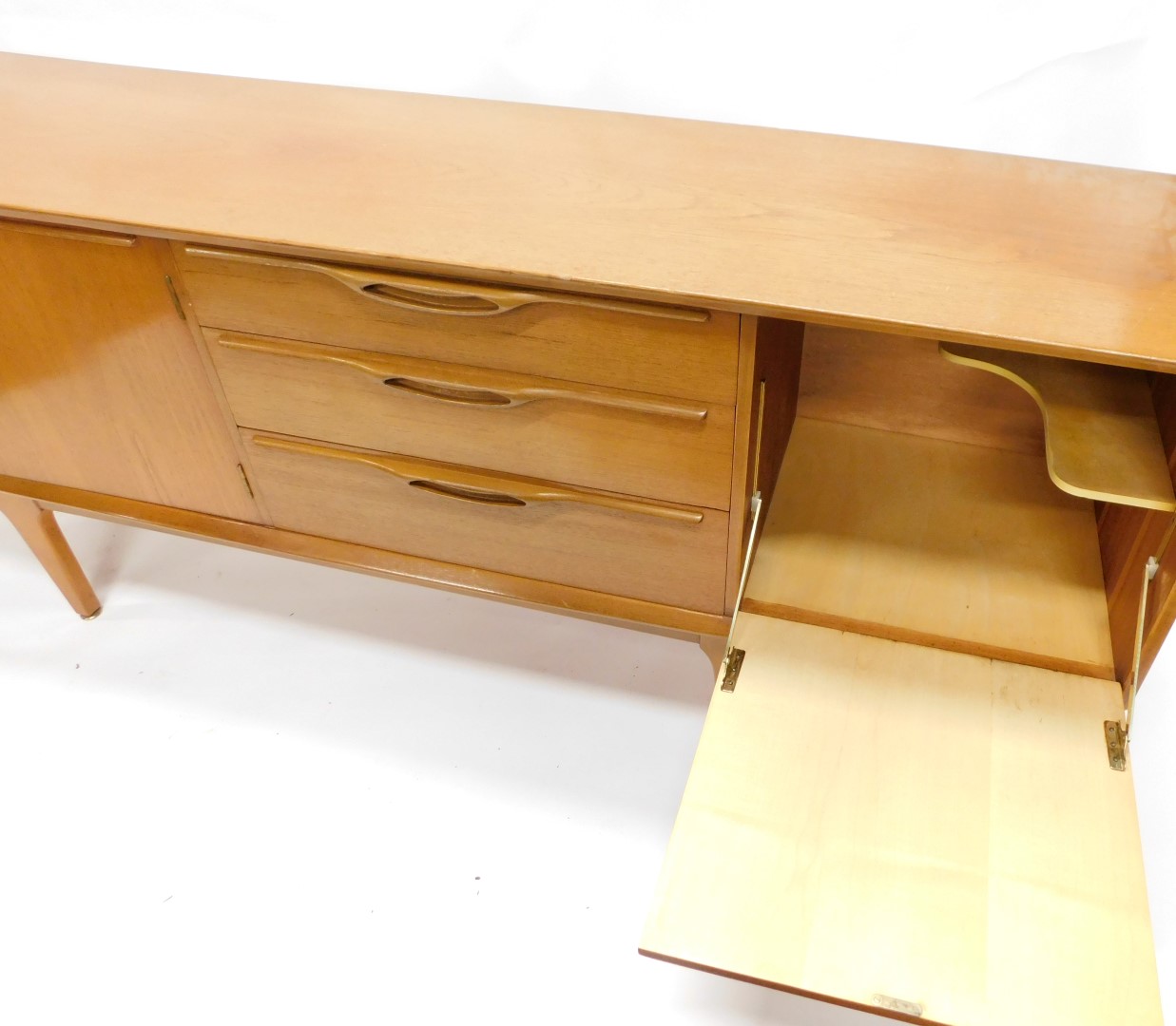 A 1960s/70s teak low sideboard, with arrangement of three drawers and three doors, on square taperin - Image 4 of 4