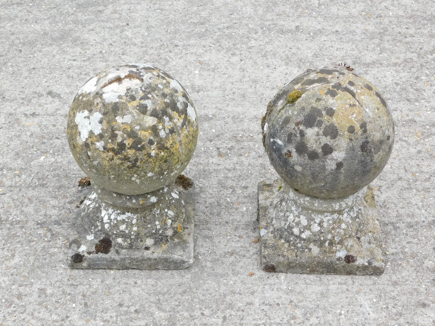 A pair of reconstituted orb shaped gate finials, 32cm high.