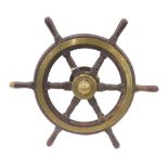 An early 20thC brass and wood ship's wheel, with turned handles, wall mount, possibly from a yacht,