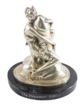 A silvered metal Art Deco style sculpture, modelled in the form of a lady riding a phallus, bearing
