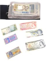 A collection of world banknotes, comprising Canadian dollars, Portuguese notes, Bank of Polski, Germ