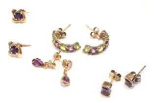 Four pairs of 9ct gold earrings, comprising a pair of 9ct gold amethyst and peridot set hoop earring