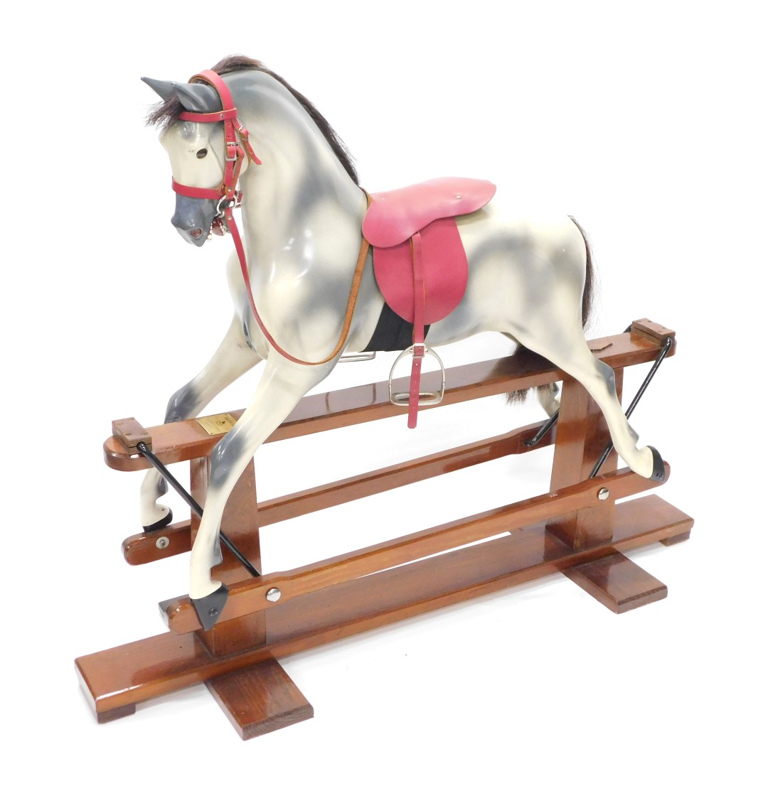 A Haddon dapple grey rocking horse, on a wooden base, brass manufacturers plaque for Haddon Makers &