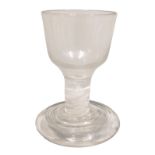 An 18thC firing glass, the bell shaped bowl, short opaque twist stem and moulded foot, 9cm high.