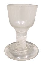 An 18thC firing glass, the bell shaped bowl, short opaque twist stem and moulded foot, 9cm high.