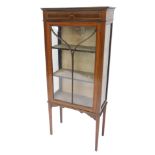 An Edwardian mahogany and boxwood strung display cabinet, with single astragal glazed door, on squar