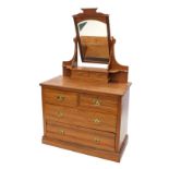 A late Victorian walnut dressing table, the raised top with an arched bevelled mirror, the base with