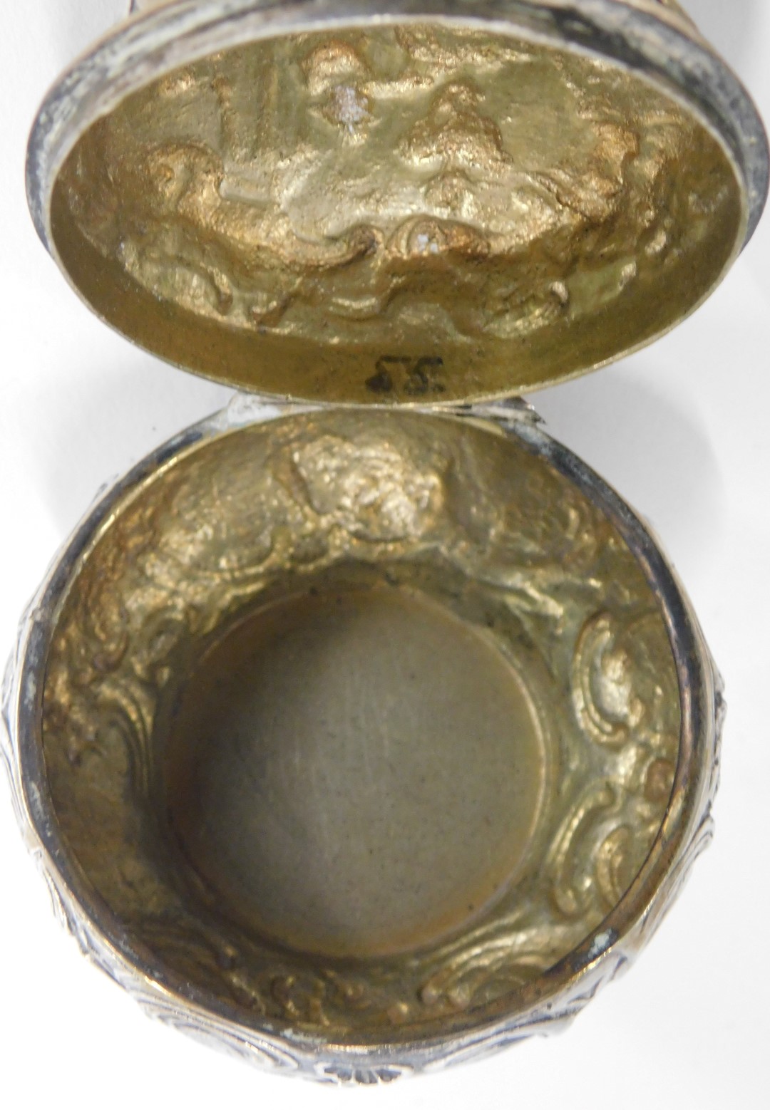 A Continental silver plated pill box, with embossed decoration of figures and animals on scroll deta - Image 4 of 4